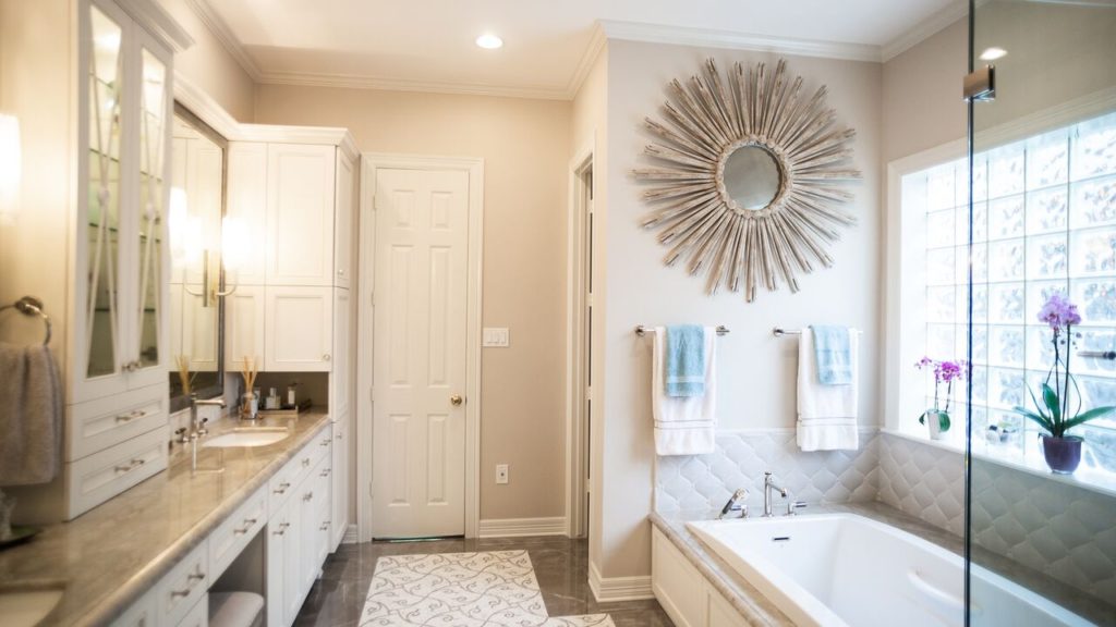 A modern bathroom with a tub and glass doors