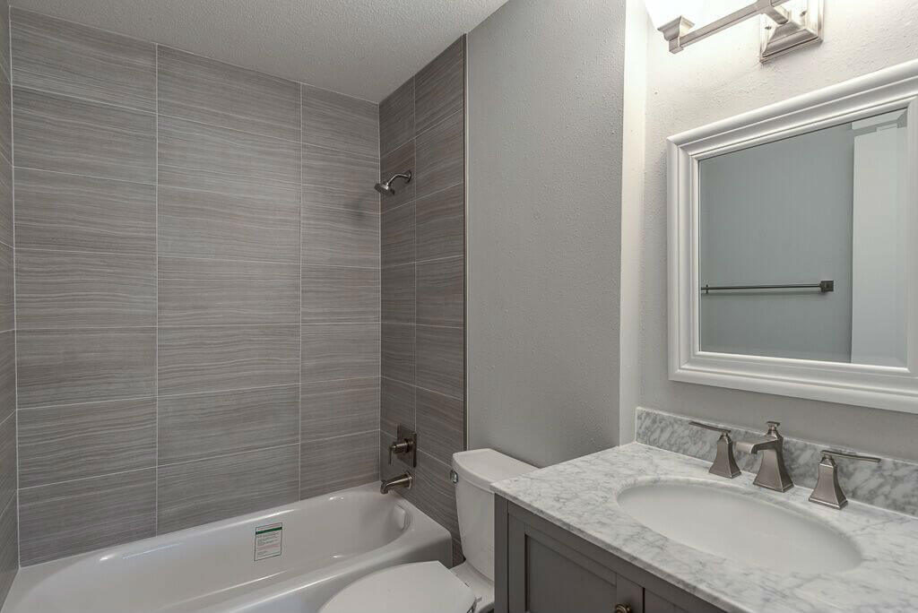 A bathroom with gray tiles