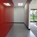 Inside view of a gym with a luxury red and white color wall