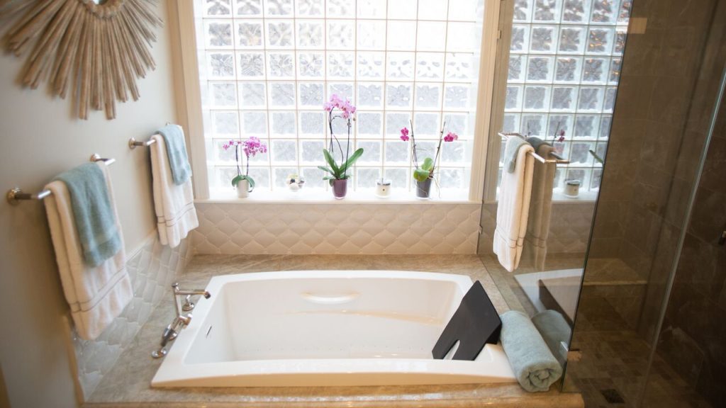 A bathtub with a frosted glass window