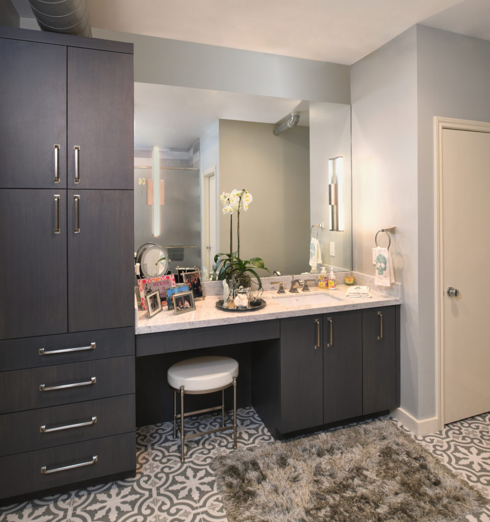 A vanity mirror near cabinets